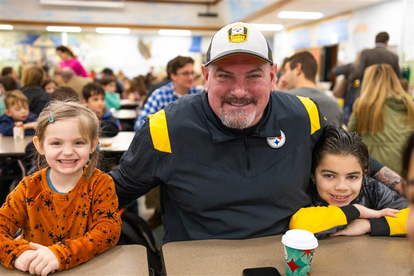 Students and their families enjoy donuts